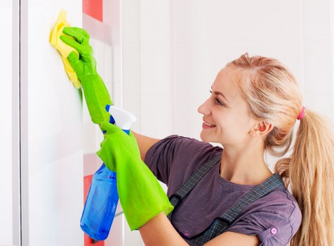 Professional cleaning technician working on hardwood floors